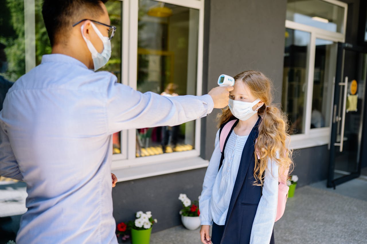 A schoolgirl undergoes a temperature screening as part of COVID-19 safety measures.